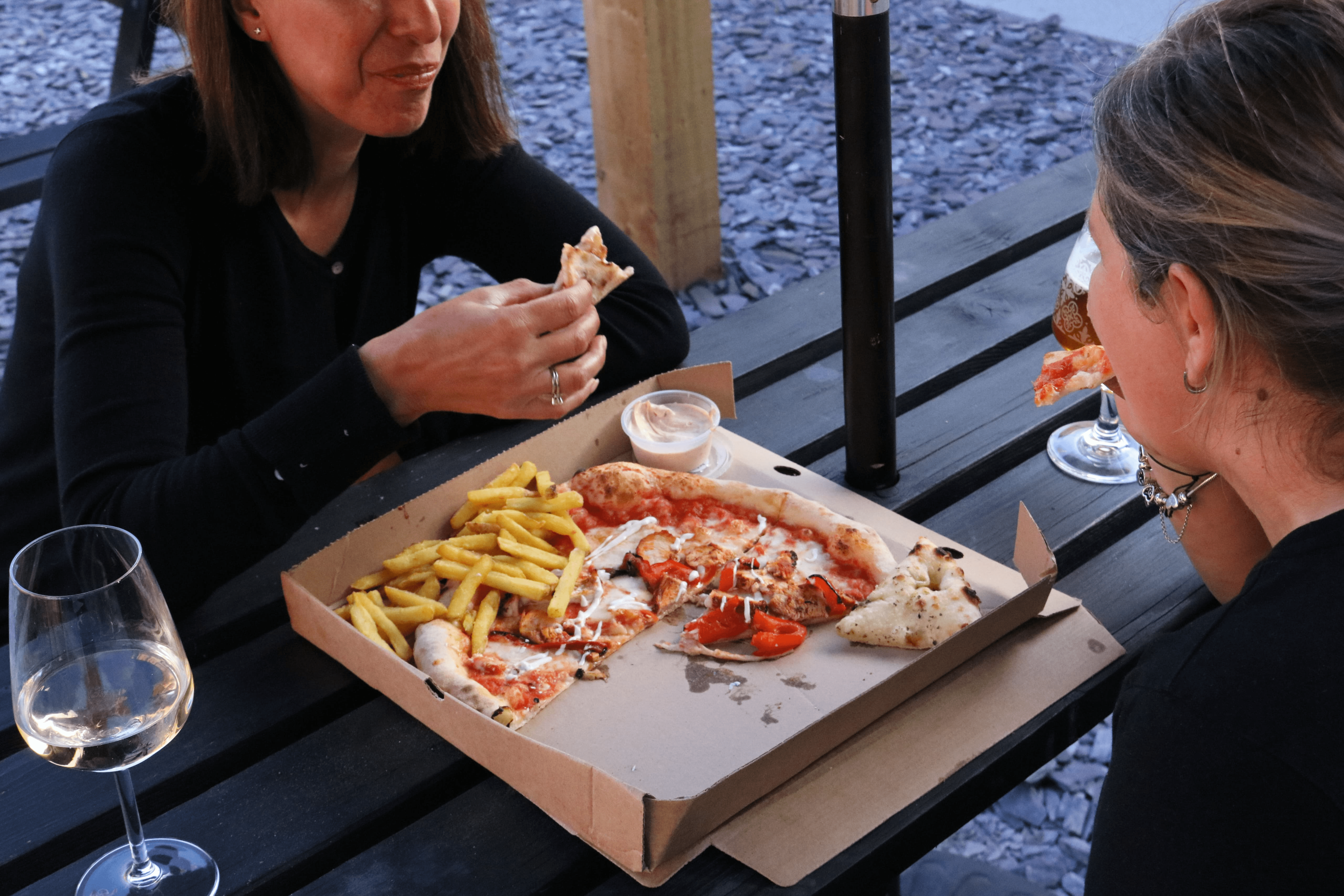 customers at melt pizza Southampton enjoying fries and tandoori chicken stone-baked pizza